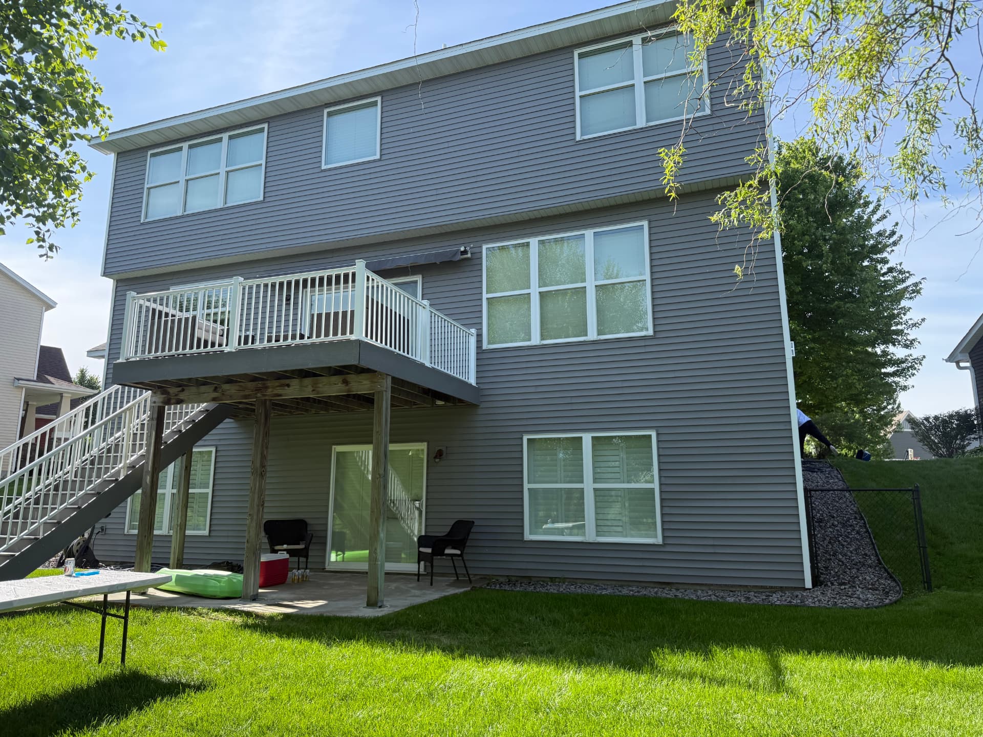Gray two-story home in Blaine MN after exterior window cleaning