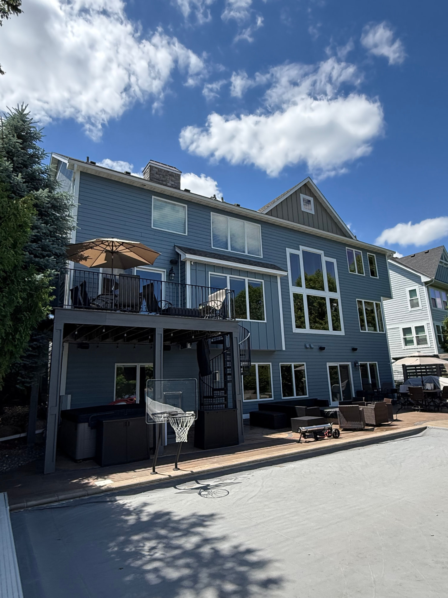 Blue three-story home in Andover MN with freshly cleaned windows