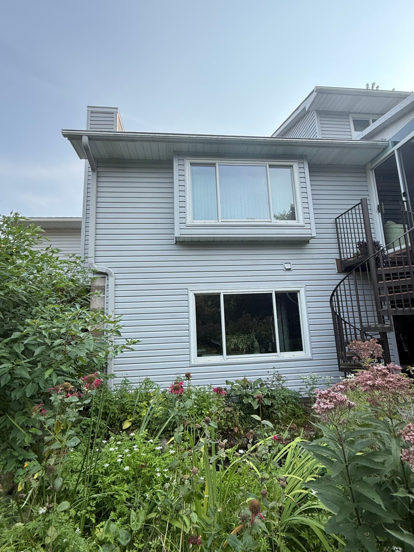 Clean light blue siding after a house wash in Lino Lakes, Minnesota