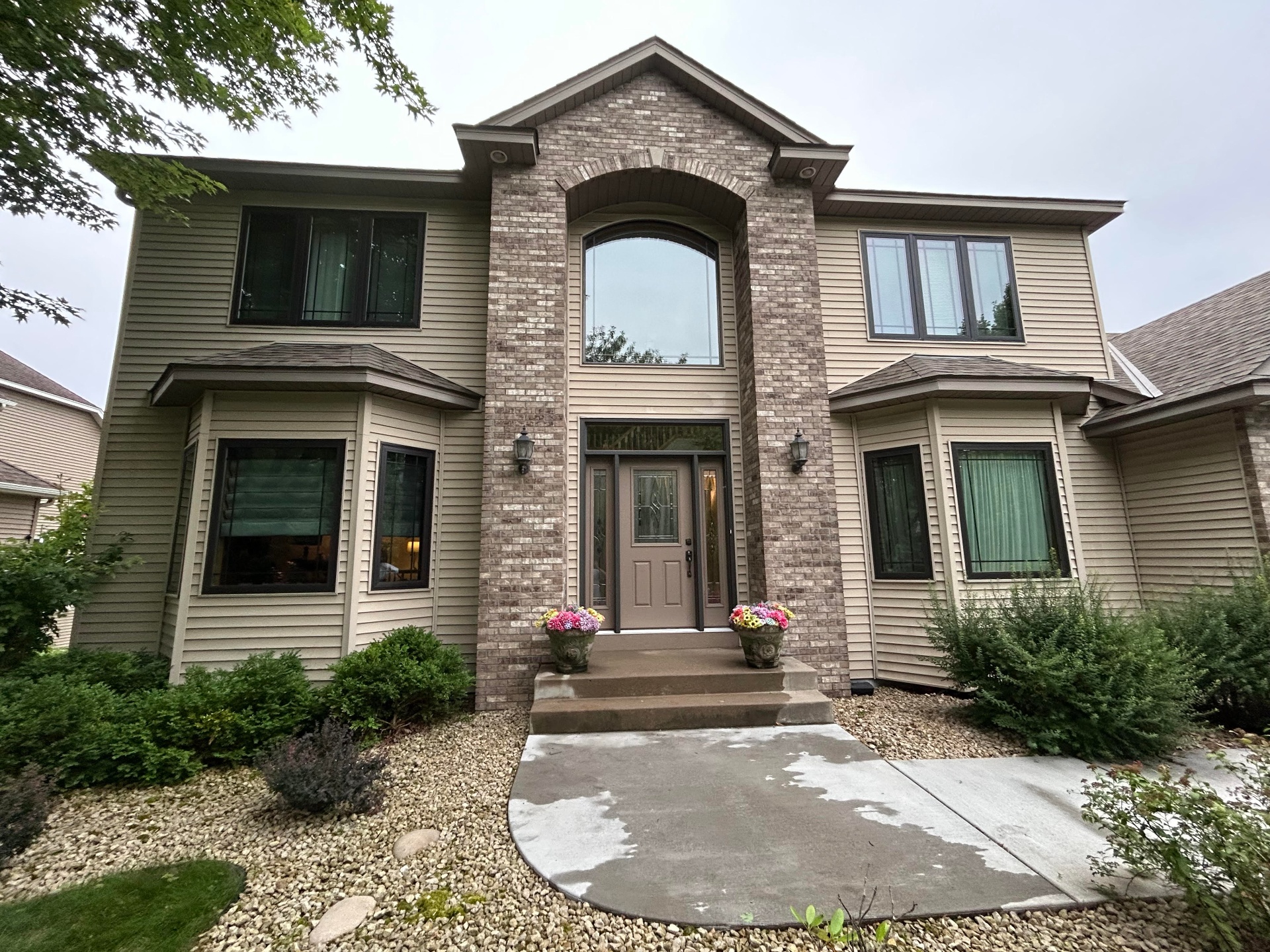 Two-story home with freshly cleaned windows
